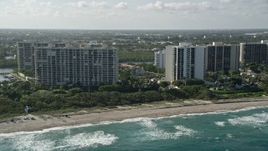 5K aerial stock footage of flying by apartment buildings on the beach, Boca Raton, Florida Aerial Stock Footage | AX0032_031