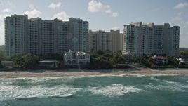 5K aerial stock footage of flying by condominium complexes near the beach, Highland Beach, Florida Aerial Stock Footage | AX0032_036