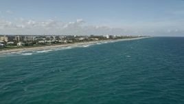 5K aerial stock footage of flying over ocean waves, revealing homes on the coast, Highland Beach, Florida Aerial Stock Footage | AX0032_040