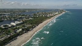 5K aerial stock footage of following the coast near Boynton Beach Park to approach condos, Boynton Beach, Florida Aerial Stock Footage | AX0032_052E