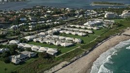 5K aerial stock footage of following the coast, approaching beachside villas, Boynton Beach, Florida Aerial Stock Footage | AX0032_054