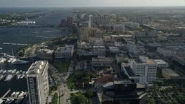 5K aerial stock footage of panning across office buildings, revealing boats docked, West Palm Beach, Florida Aerial Stock Footage | AX0032_085