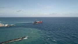 5K aerial stock footage of approaching and orbiting a dredging ship near the coast, Palm Beach Shores, Florida Aerial Stock Footage | AX0032_110E
