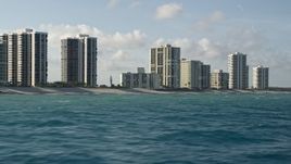 5K aerial stock footage of passing by coastal condominium complexes, Riviera Beach, Florida Aerial Stock Footage | AX0032_118