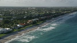 5K aerial stock footage of panning across homes by the beach on the coast, North Palm Beach, Florida Aerial Stock Footage | AX0032_124