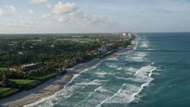 5K aerial stock footage video of following the coast past mansions and beach, North Palm Beach, Florida Aerial Stock Footage | AX0032_125E