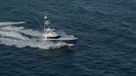 5K aerial stock footage of tracking a fishing boat racing across the Atlantic, Jupiter, Florida Aerial Stock Footage | AX0032_144