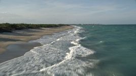 5K aerial stock footage of flying low over the beach, Saint Lucie Inlet Preserve State Park, Stuart, Florida Aerial Stock Footage | AX0032_152E