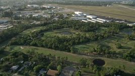 5K aerial stock footage of flying by Martin County Golf and Country Club, tilt down on pond, Stuart, Florida Aerial Stock Footage | AX0032_162