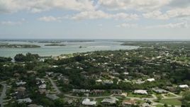 5K aerial stock footage of flying over waterfront neighborhood toward an inlet, Stuart, Florida Aerial Stock Footage | AX0033_002