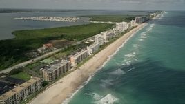5K aerial stock footage of beachside apartment buildings and blue ocean waters, Jensen Beach, Florida Aerial Stock Footage | AX0033_012