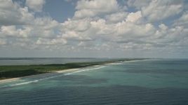 5K aerial stock footage fly over blue ocean waters while following the coast, Fort Pierce, Florida Aerial Stock Footage | AX0033_022