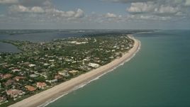 5K aerial stock footage of following the beach by residential neighborhoods Vero Beach, Florida Aerial Stock Footage | AX0033_055E