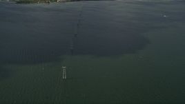 5K aerial stock footage of orbiting power lines crossing a river, Melbourne Beach, Florida Aerial Stock Footage | AX0033_072