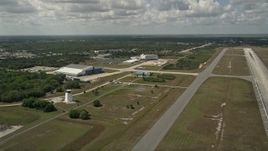 5K aerial stock footage flyby a runway and hangar at Melbourne Regional Airport, Florida Aerial Stock Footage | AX0033_082