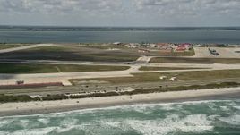 5K aerial stock footage fly by a turboprop plane on the runway, Patrick Air Force Base, Florida Aerial Stock Footage | AX0034_004