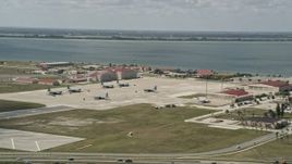 5K aerial stock footage of parked turboprop military planes, Patrick Air Force Base, Florida Aerial Stock Footage | AX0034_005