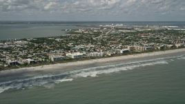 5K aerial stock footage fly by a beach with hotels and condominiums, Cocoa Beach, Florida Aerial Stock Footage | AX0034_012
