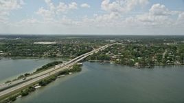 5K aerial stock footage of panning across a causeway revealing residential neighborhoods, Cocoa, Florida Aerial Stock Footage | AX0034_026E