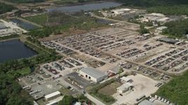 5K aerial stock footage of approaching an auto salvage lot, Cocoa, Florida Aerial Stock Footage | AX0034_030
