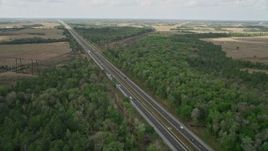 5K aerial stock footage of following an Expressway through trees and a rural area, La Belle, Florida Aerial Stock Footage | AX0034_064E