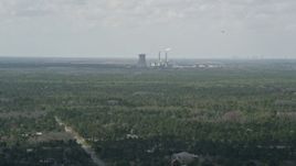 5K aerial stock footage fly over trees toward a coal fired power generation facility, Orlando, Florida Aerial Stock Footage | AX0034_072
