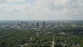 5K aerial stock footage fly over trees toward Downtown Orlando, Florida Aerial Stock Footage | AX0034_083E