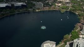 5K aerial stock footage of approaching a fountain in the center of the lake, Downtown Orlando, Florida Aerial Stock Footage | AX0034_112