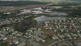 5K aerial stock footage flyby residential neighborhood and wetlands, Clermont, Florida Aerial Stock Footage | AX0035_085