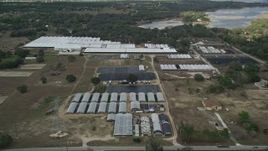 5K aerial stock footage approach greenhouses at a farm in Winter Garden, Florida Aerial Stock Footage | AX0035_096