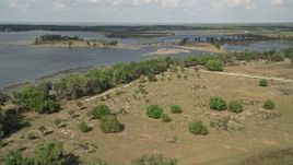 5K aerial stock footage fly over Johns Lake toward trees on the shore, Florida Aerial Stock Footage | AX0035_101E