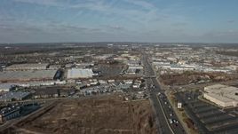 5K aerial stock footage follow Broadhollow Road to approach stores and shopping centers in Farmingdale, Long Island, New York, winter Aerial Stock Footage | AX0065_0002