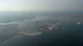5K aerial stock footage of Rikers Island on the East River as a commercial jet approaches LaGuardia Airport, Queens, New York City, winter Aerial Stock Footage | AX0065_0035