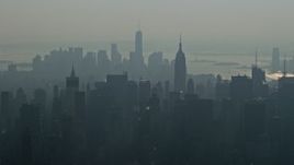 5K aerial stock footage of Empire State Building and Midtown Manhattan skyscrapers, and Lower Manhattan skyscrapers in the background, New York City, winter Aerial Stock Footage | AX0065_0044E