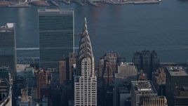 5K aerial stock footage of the top of the Chrysler Building, United Nations in the background, Midtown Manhattan, New York City, winter Aerial Stock Footage | AX0065_0062