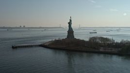 5K aerial stock footage flyby the back of the Statue of Liberty, New York, winter Aerial Stock Footage | AX0065_0076E