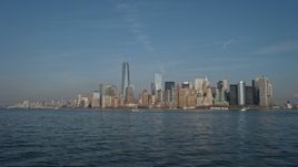 5K aerial stock footage tilt from New York Harbor to reveal and approach the Lower Manhattan skyline, New York City, winter Aerial Stock Footage | AX0065_0084E