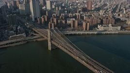 5K aerial stock footage tilt to heavy traffic crossing the Brooklyn Bridge, New York City, winter Aerial Stock Footage | AX0065_0104