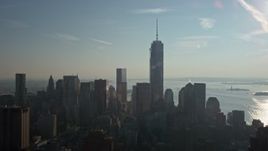 5K aerial stock footage of a view of One World Trade Center towering over Lower Manhattan skyscrapers, New York City, winter Aerial Stock Footage | AX0065_0110