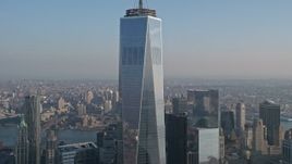 5K aerial stock footage tilt down the side of Freedom Tower from the spire down the side in Lower Manhattan, New York City, winter Aerial Stock Footage | AX0065_0122E