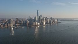 5K aerial stock footage fly over Hudson River to approach the Lower Manhattan skyline, New York City, winter Aerial Stock Footage | AX0065_0133E