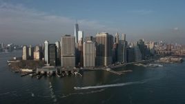 5K aerial stock footage of Lower Manhattan skyscrapers, Battery Park, and the East River, New York City, winter Aerial Stock Footage | AX0065_0140E