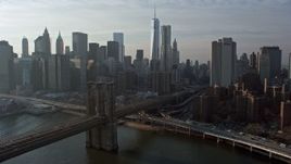 5K aerial stock footage approach and fly over the Brooklyn Bridge with view of the Lower Manhattan skyline, New York City, winter Aerial Stock Footage | AX0065_0149E