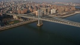 5K aerial stock footage of light traffic crossing the Manhattan Bridge, New York City, winter Aerial Stock Footage | AX0065_0154
