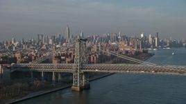 5K aerial stock footage of light traffic on the Williamsburg Bridge, with Midtown Manhattan skyline in the background, New York City, winter Aerial Stock Footage | AX0065_0157