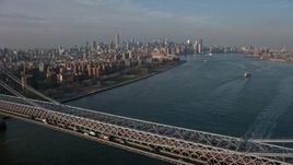 5K aerial stock footage fly over the Williamsburg Bridge toward Midtown Manhattan skyline in the background, New York City, winter Aerial Stock Footage | AX0065_0158
