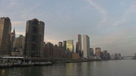 5K aerial stock footage fly low over East River by riverfront condominium complexes and United Nations in Midtown Manhattan, New York City, winter, sunset Aerial Stock Footage | AX0065_0167