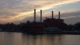 5K aerial stock footage fly low by an East Village power plant with Lower Manhattan skyline in the distance, New York City, winter, sunset Aerial Stock Footage | AX0065_0169
