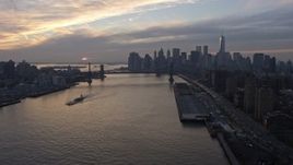 5K aerial stock footage view of Lower Manhattan skyline from Lower East Side public housing, Williamsburg Bridge, reveal Manhattan BridgeNYC, winter, sunset Aerial Stock Footage | AX0065_0172E