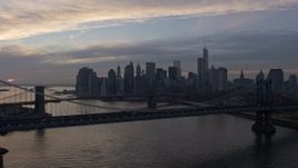 5K aerial stock footage fly over Manhattan Bridge, approach the Brooklyn Bridge and Lower Manhattan skyline, New York City, winter, twilight Aerial Stock Footage | AX0065_0175E
